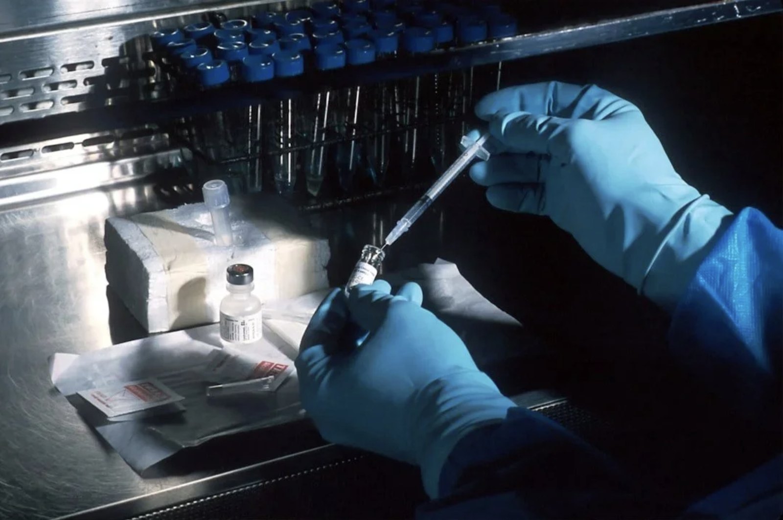 Clinician preparing an infusion in a sterile compounding hood