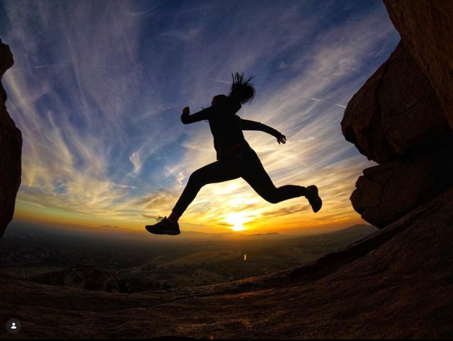 Athlete leaping at sunset over the Inland Empire